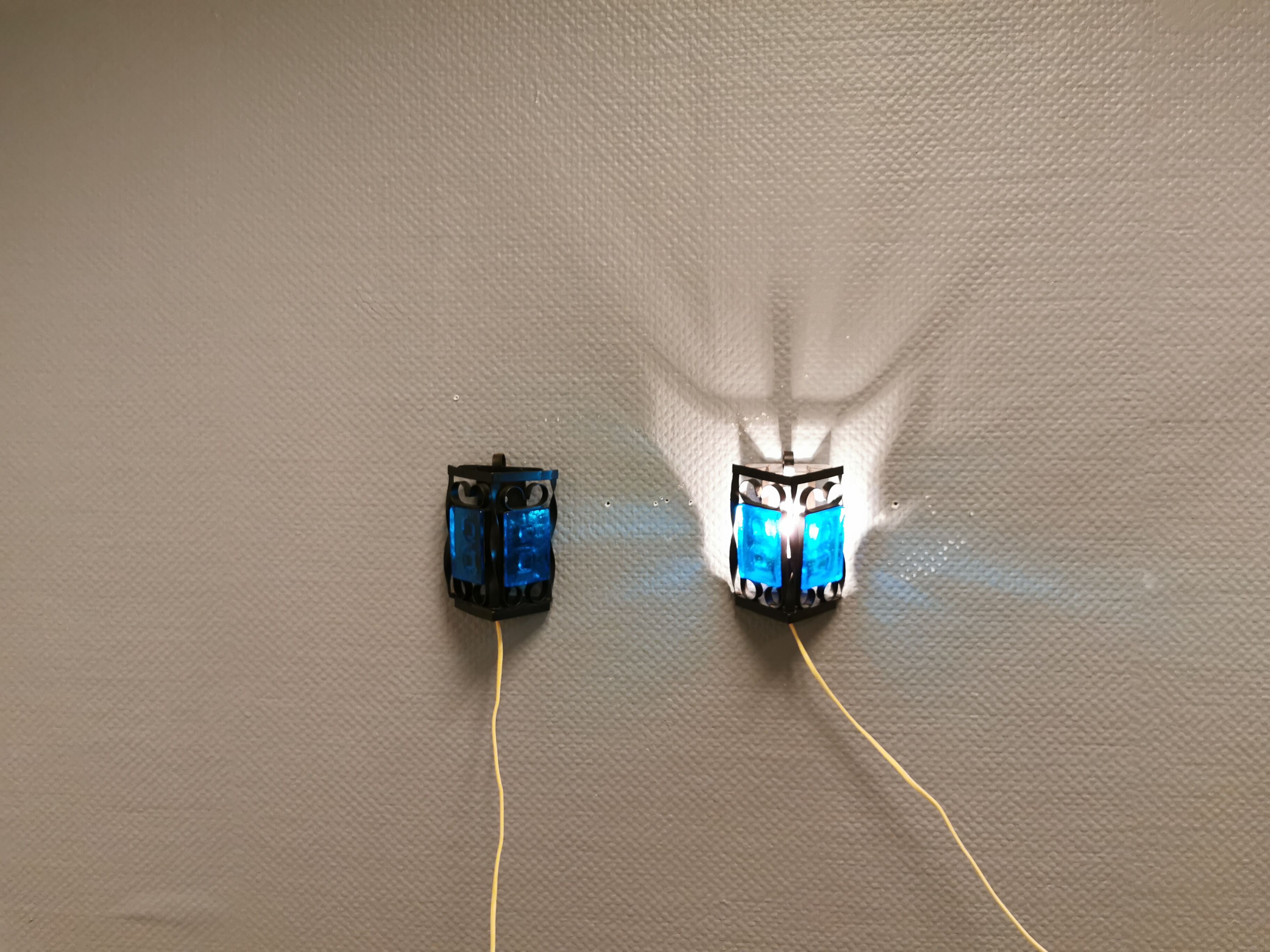 Wall lamps made of black cast iron and handmade thick pressed blue glass