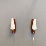 Danish wall lights from the 1970s, made of milky white glass shades, teak wood suspension and brass.