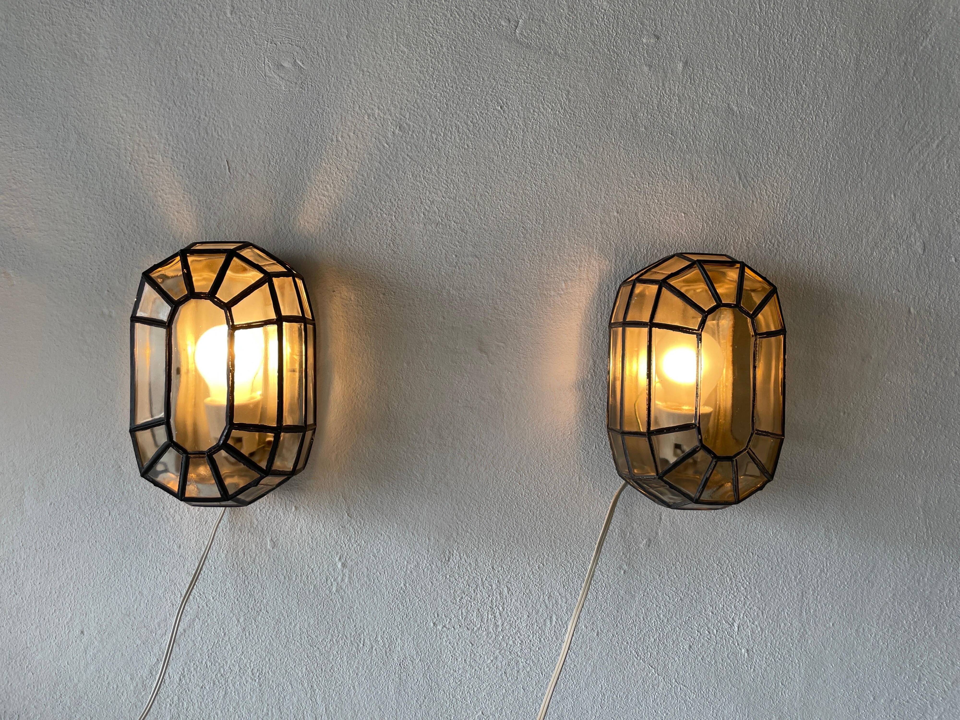 Pair of black iron wall sconces with structured glass by Limburg, 1960s, Germany.