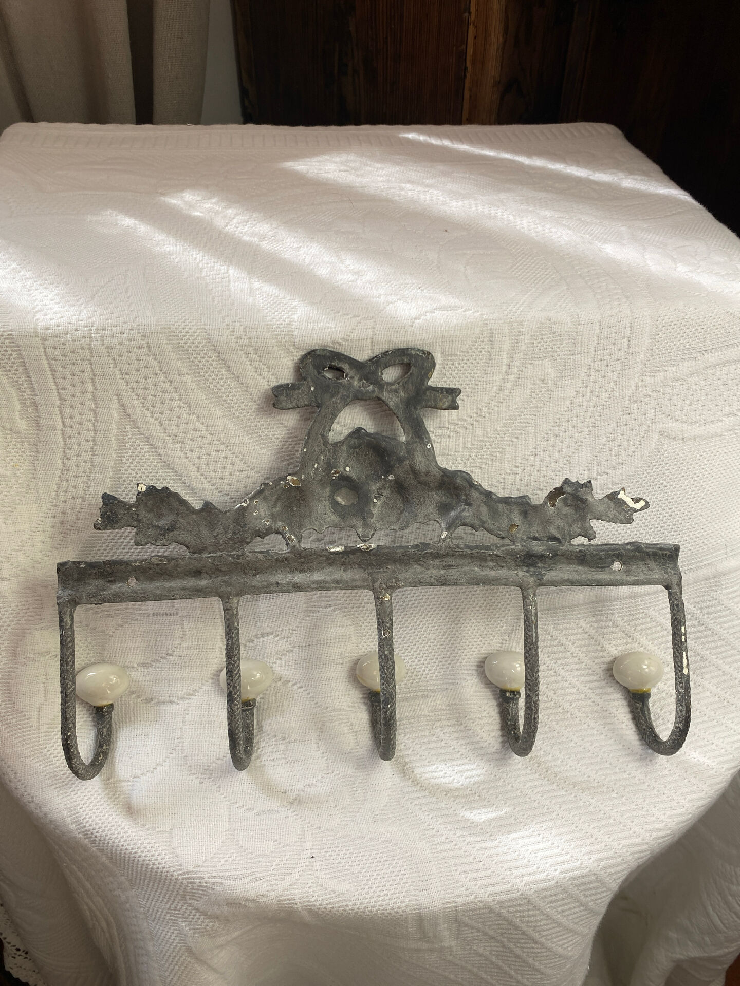 Patinated metal wall bracket and porcelain