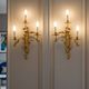 Pair of gilded bronze wall sconces in Rococo style, three lights.
