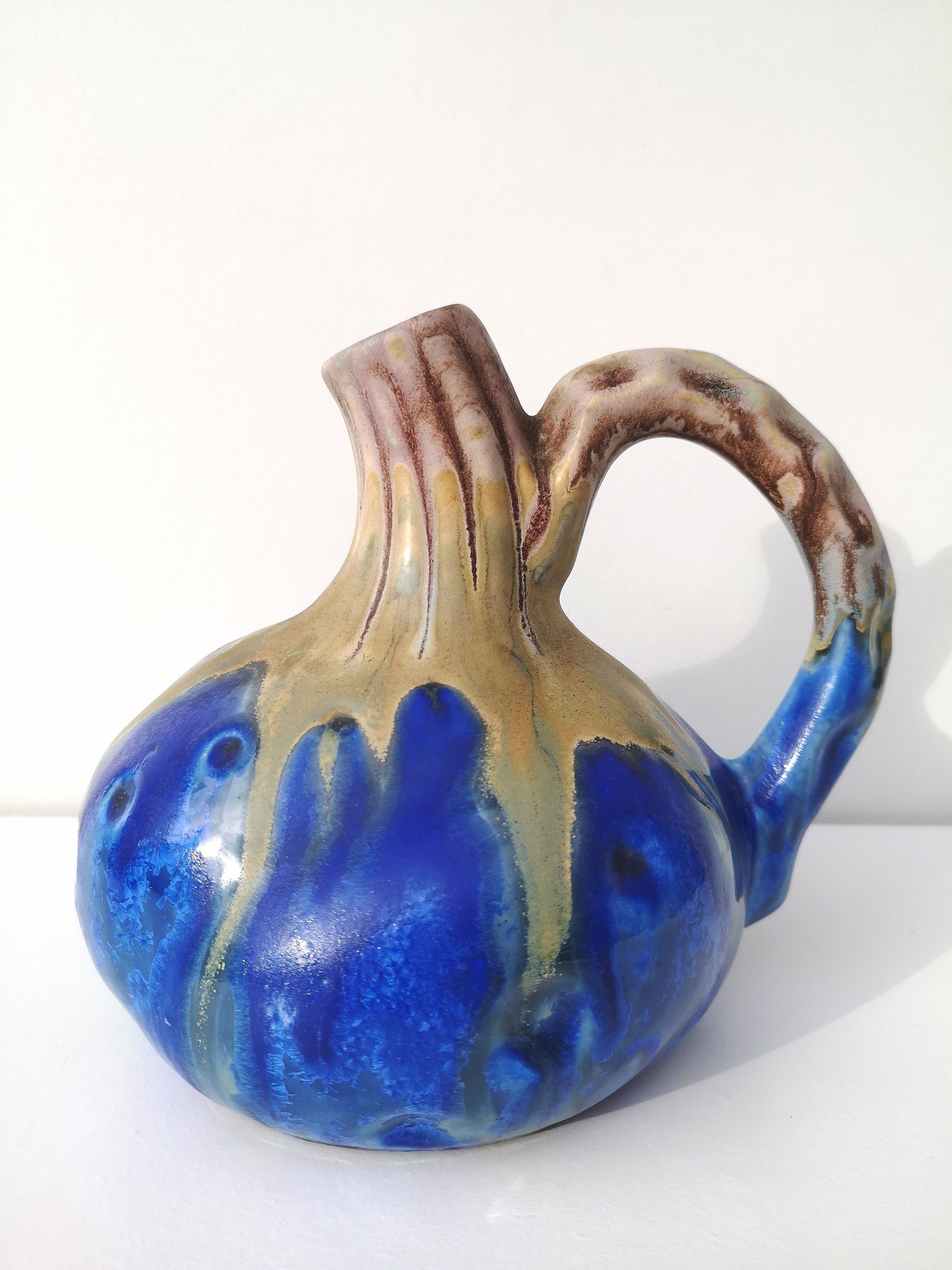 Vintage decanter in enamelled earthenware