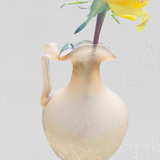 Old decorative carafe in li-colored glass