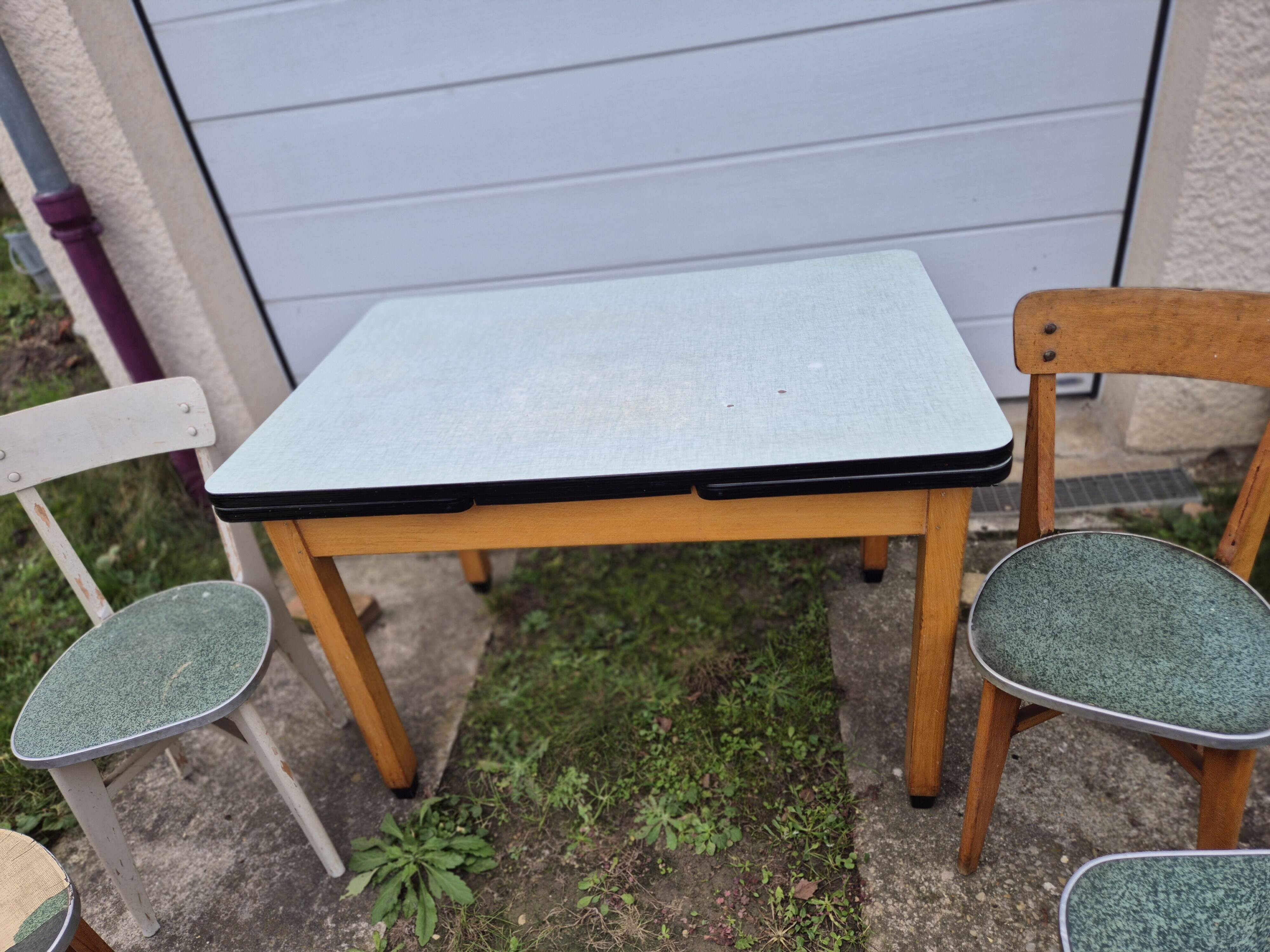 Vintage Scandinavian table and chair set with a wooden frame and formica top.