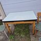 Vintage Scandinavian table and chair set with a wooden frame and formica top.