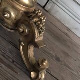 A gilded carved wooden pedestal table with a marble marquetry top