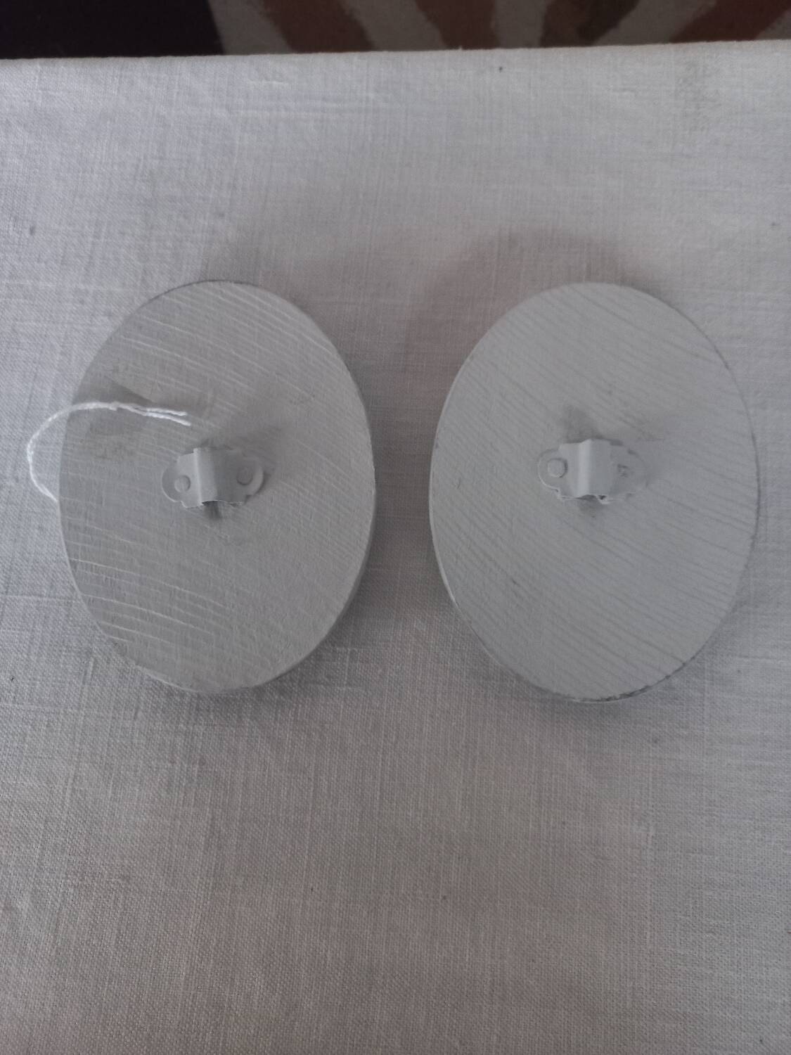 Pair of patinated oval woodwork