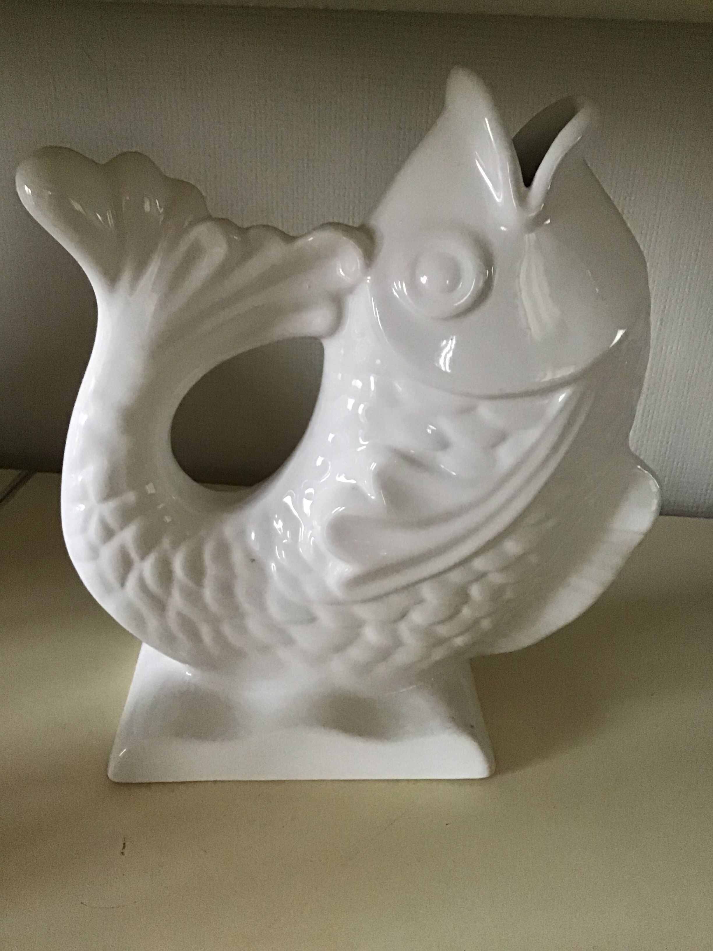 White ceramic vase in the shape of fish