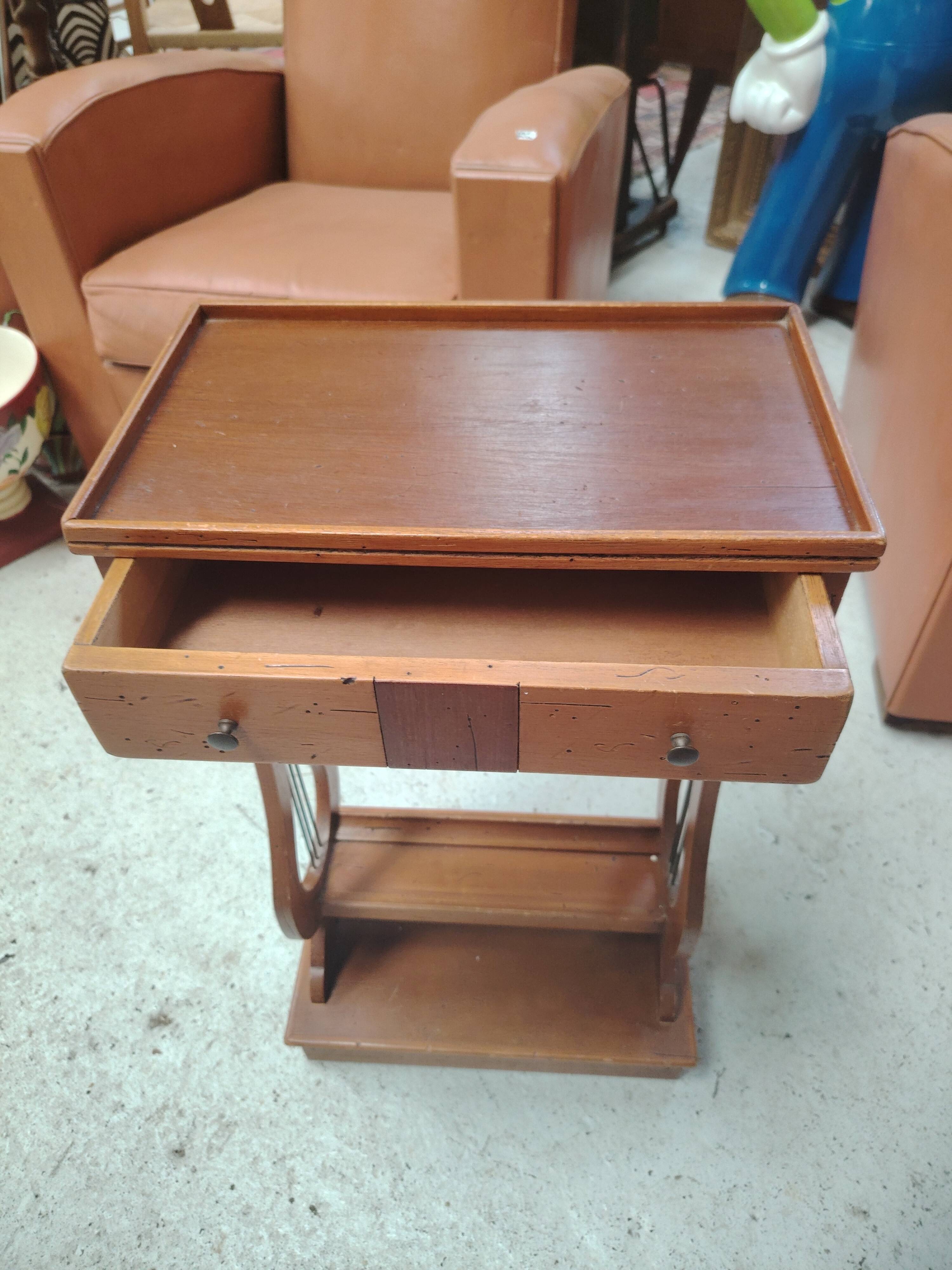 Vintage end table with lyre legs and two drawers.