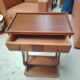 Vintage end table with lyre legs and two drawers.