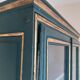 Glass-fronted cabinet in weathered green wood