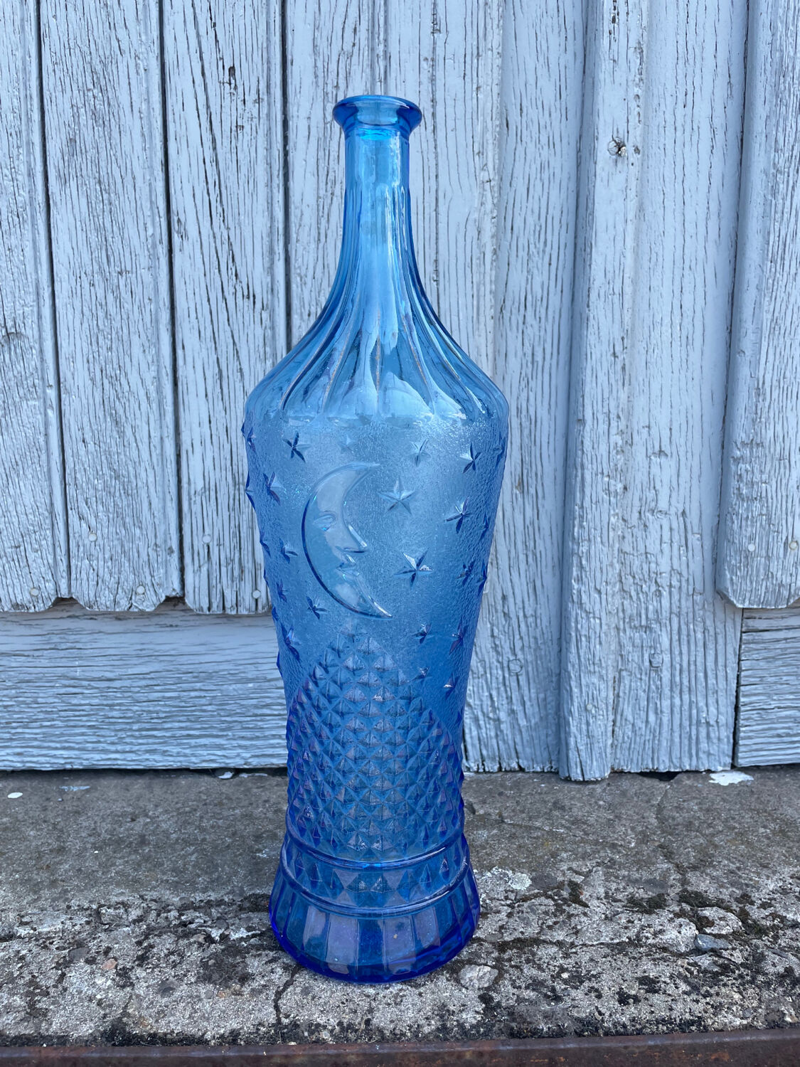 Blue glass decanter with a moon star motif