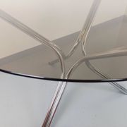 Vintage round dining table in smoked glass and chromed metal, Space Age style, from the 70s