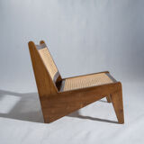 Reclined armchair in canned teak in natural wood