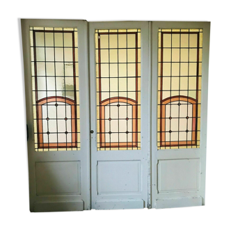 Separation of three doors in 20th century Art Deco stained glass