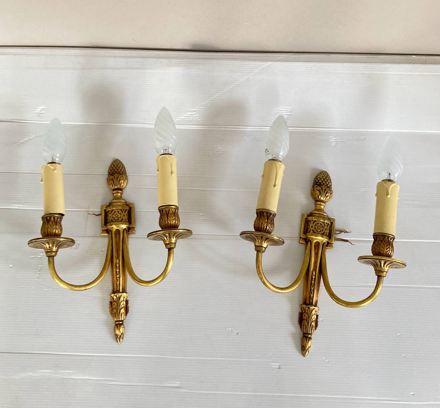 St Louis XVI gilded bronze wall lights with foliage and pine cone decorations