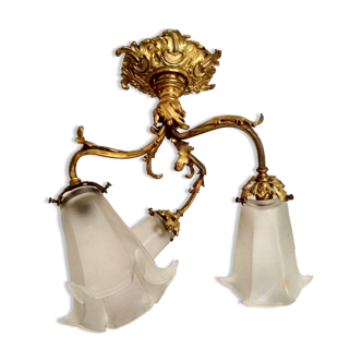 Rocker-style ceiling lights in gilded bronze and glass tulips