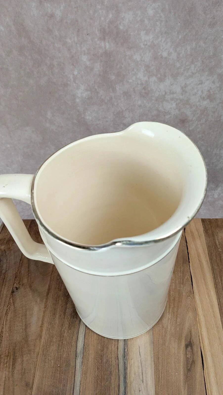 Large antique jug from Sarreguemines with golden trim.