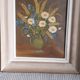 An old painting in oil on canvas depicting a bouquet of flowers.