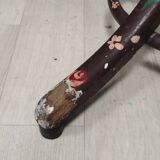 Wooden parrot coat rack with painted floral decoration.