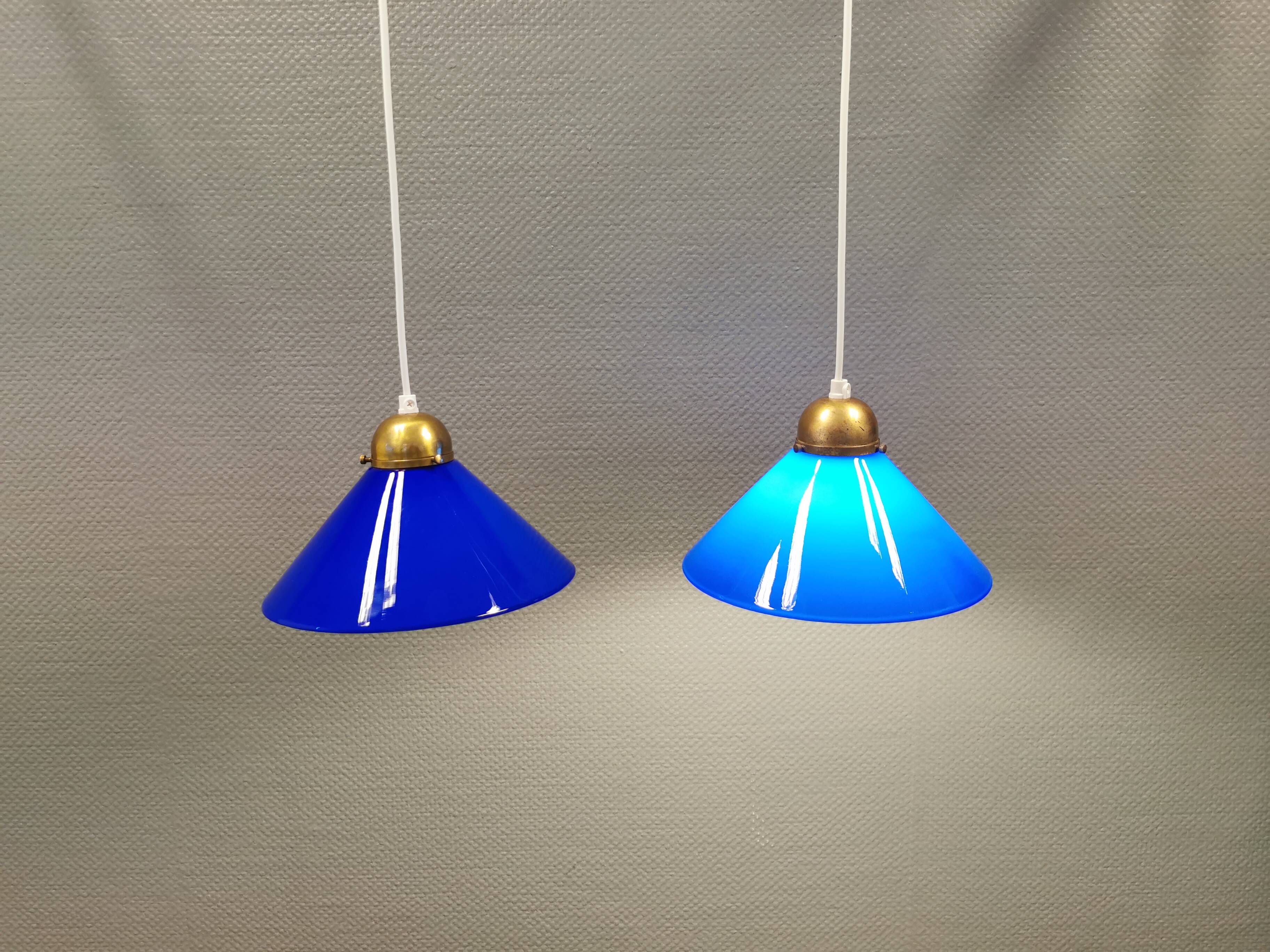 Two lamps in double layered glass with brass top. Danish and estimated from the 1960s
