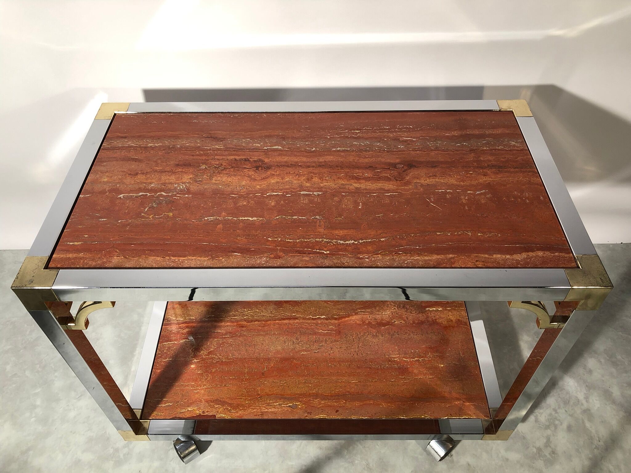 Italian rolling dessert table with two trays decorated with pink travertine