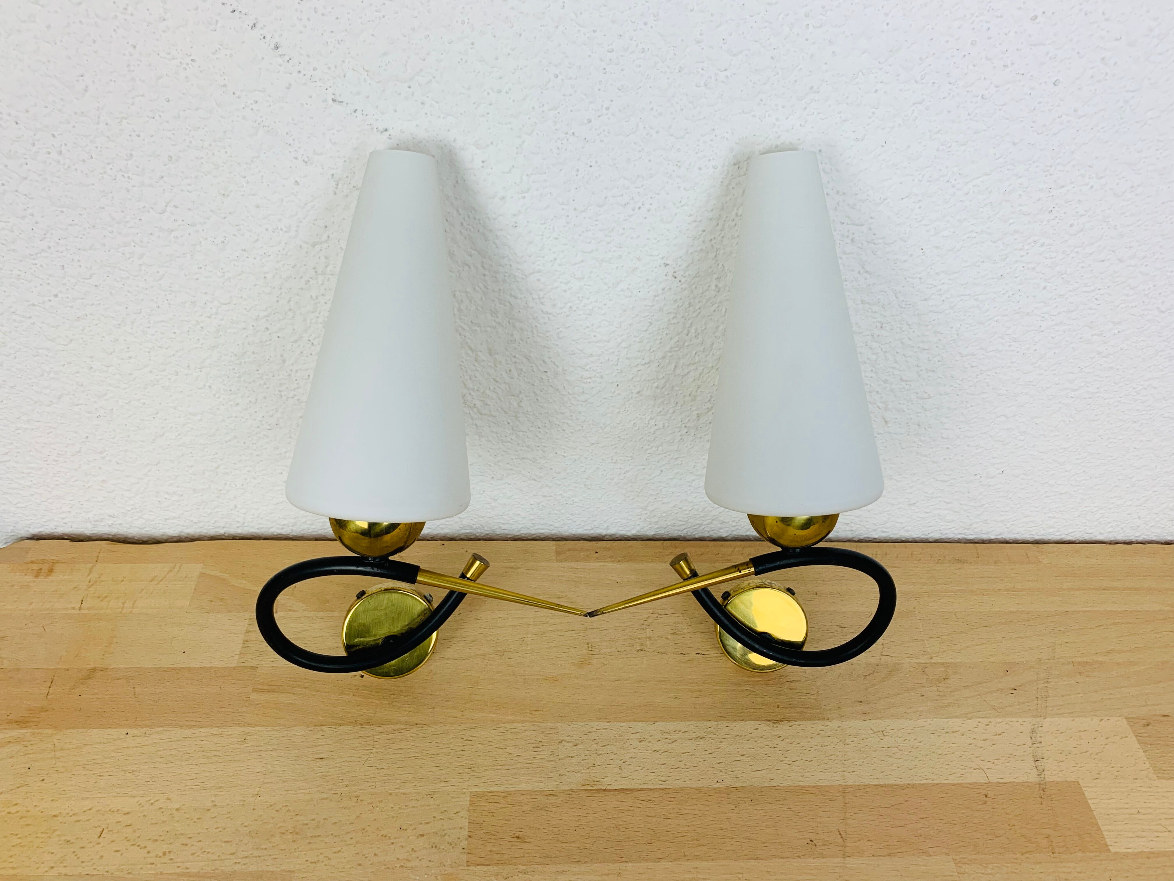 Pair of Arlus 50s opaline black and golden brass wall lamps