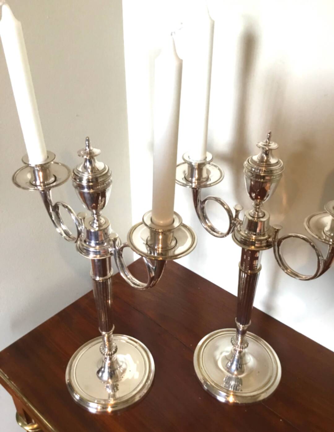 Pair of silver-plated metal candelabra decorated with hunting horns