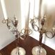 Pair of silver-plated metal candelabra decorated with hunting horns