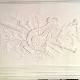 Fireplace trumeau mirror decorated with the attributes of music