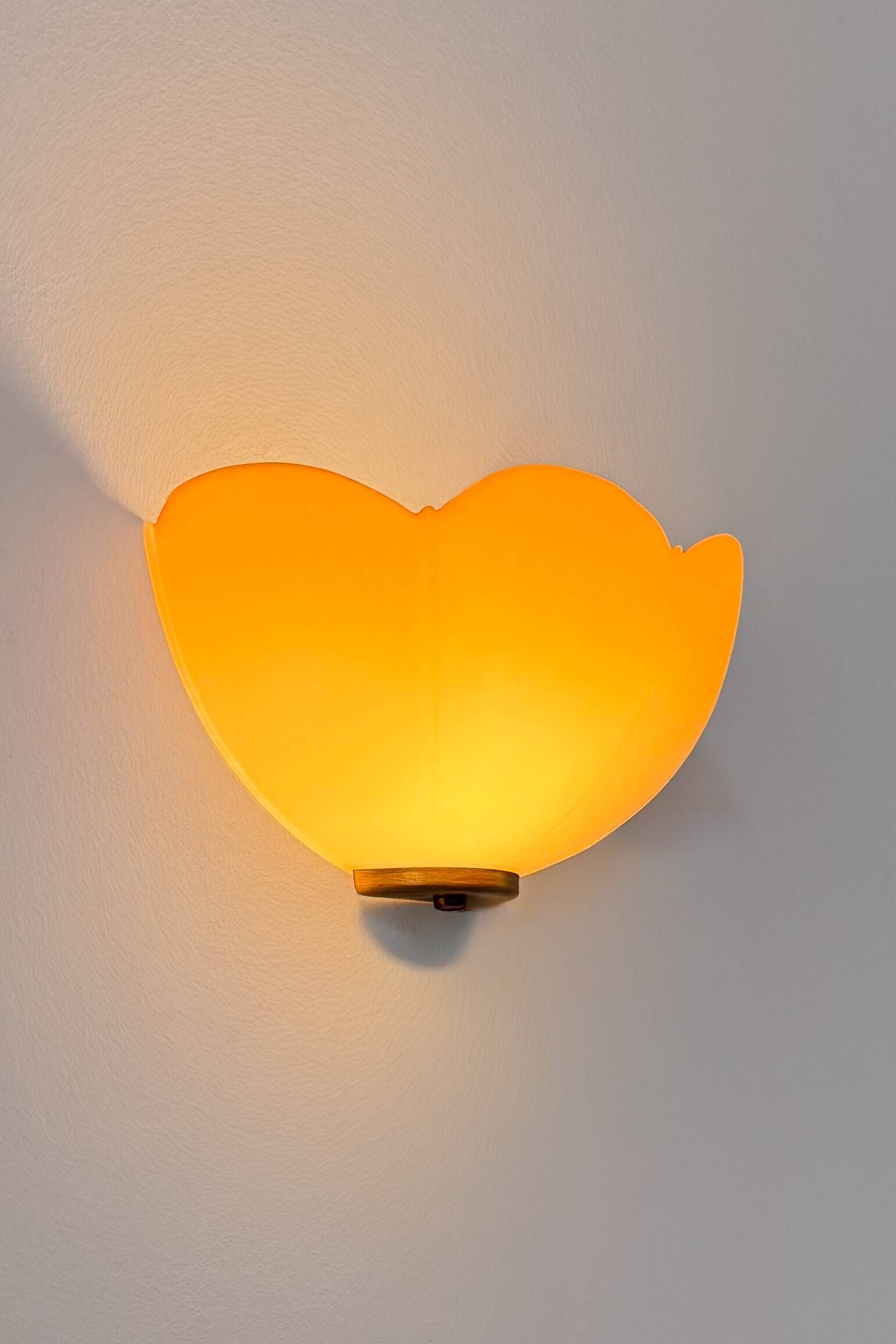 Vintage brass and orange glass wall lights, France 1970.