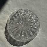 Circular glass ashtray with stylized petal patterns