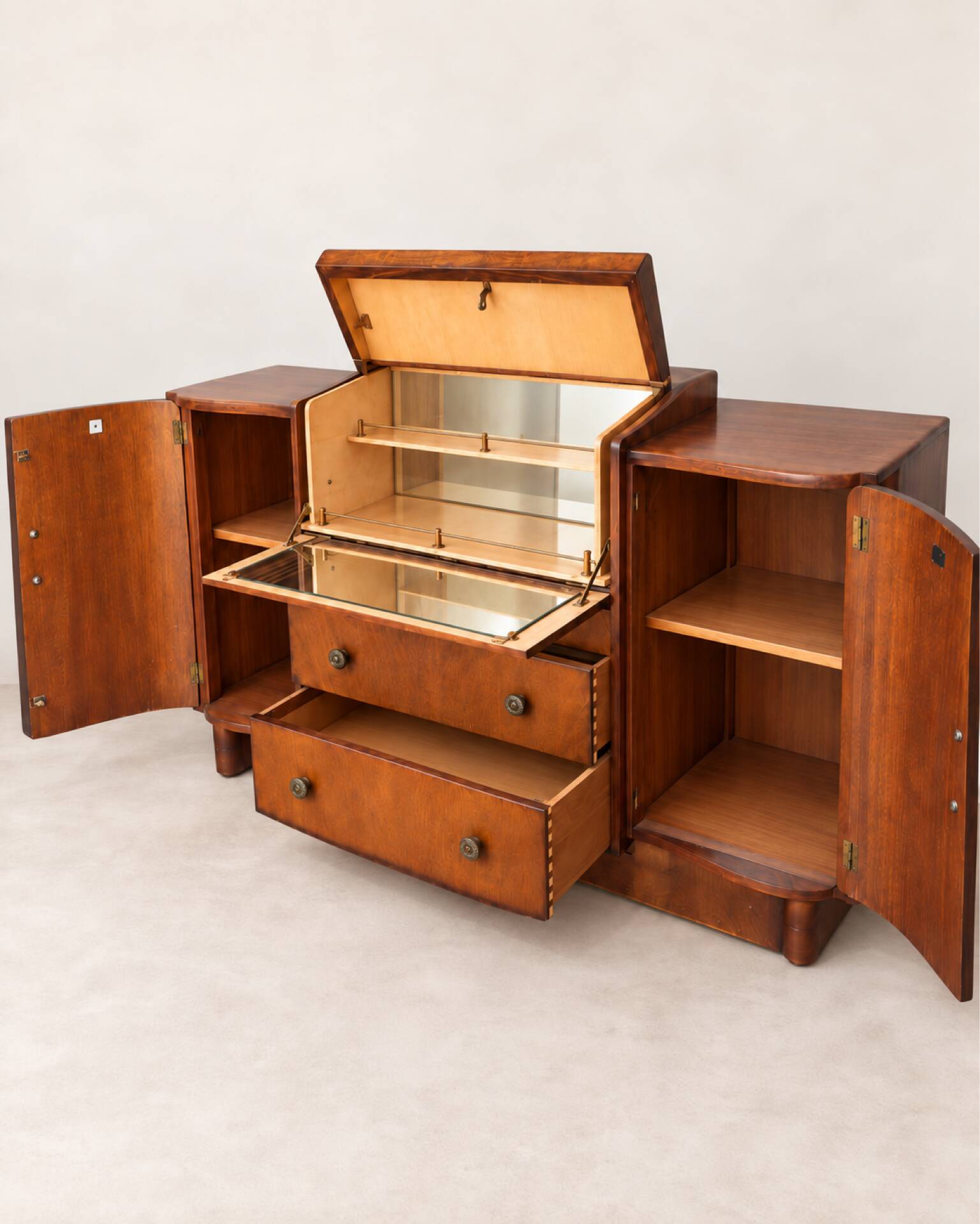 Art Deco walnut bar cabinet with a mirrored interior.