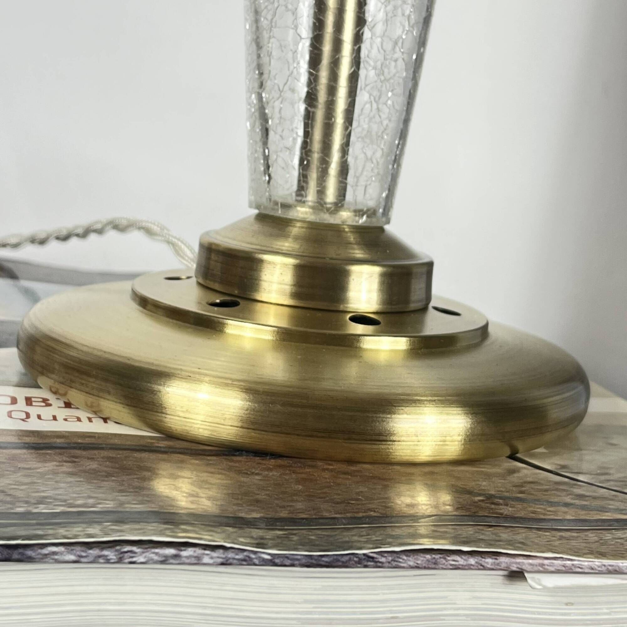 Large globe table lamp with a cracked glass base and brass stand.