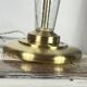 Large globe table lamp with a cracked glass base and brass stand.