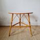 Round soft pink rattan table