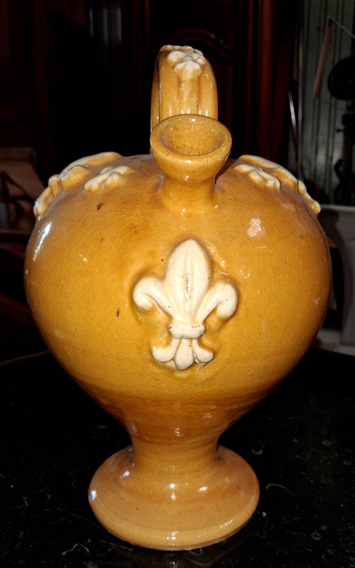 Glazed terracotta gargoyle decorated with fleur-de-lis.
