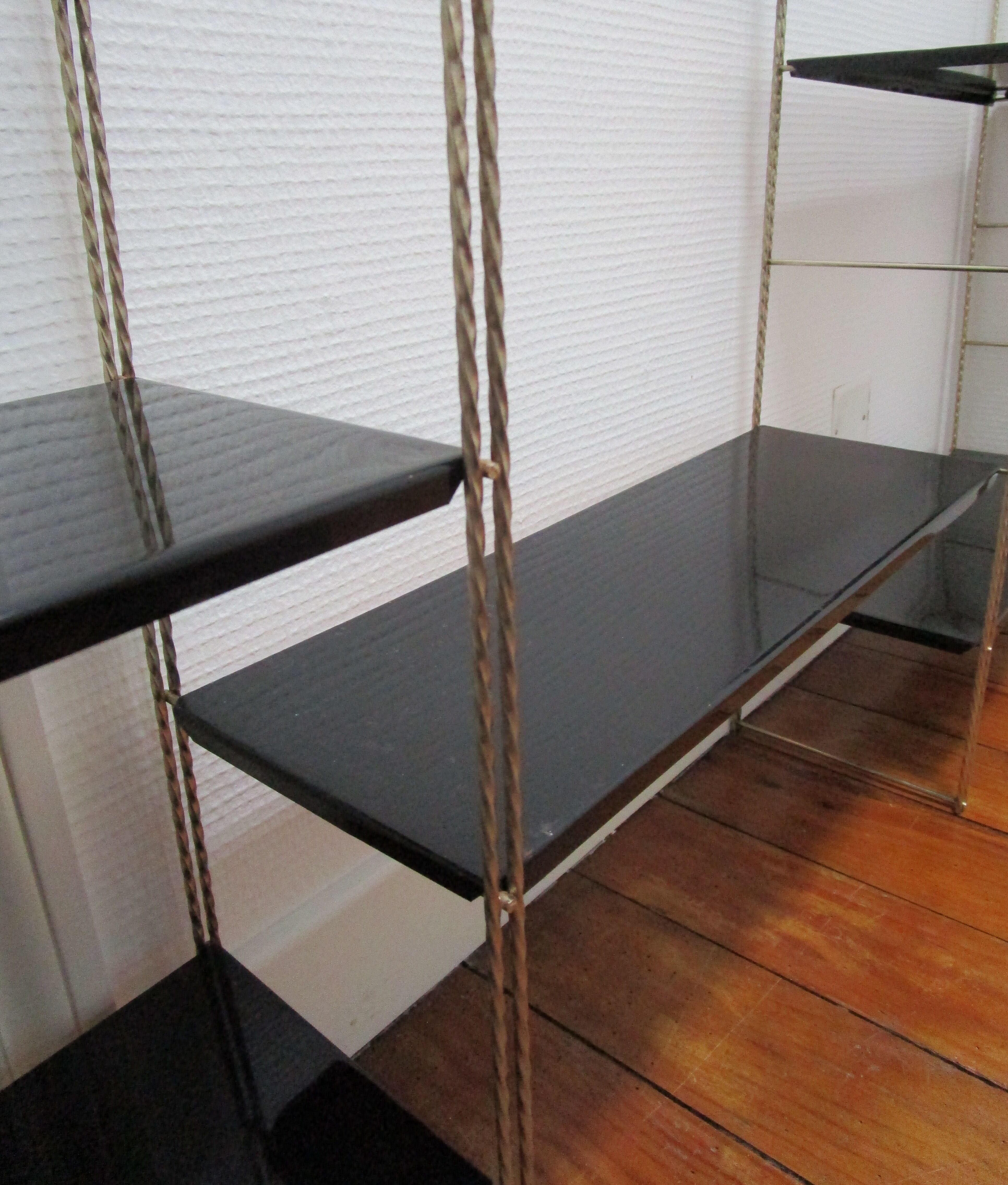 Black and gold metal tomado wall shelf