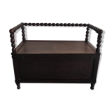 Natural wood chest forming a bench, ringed shoulders