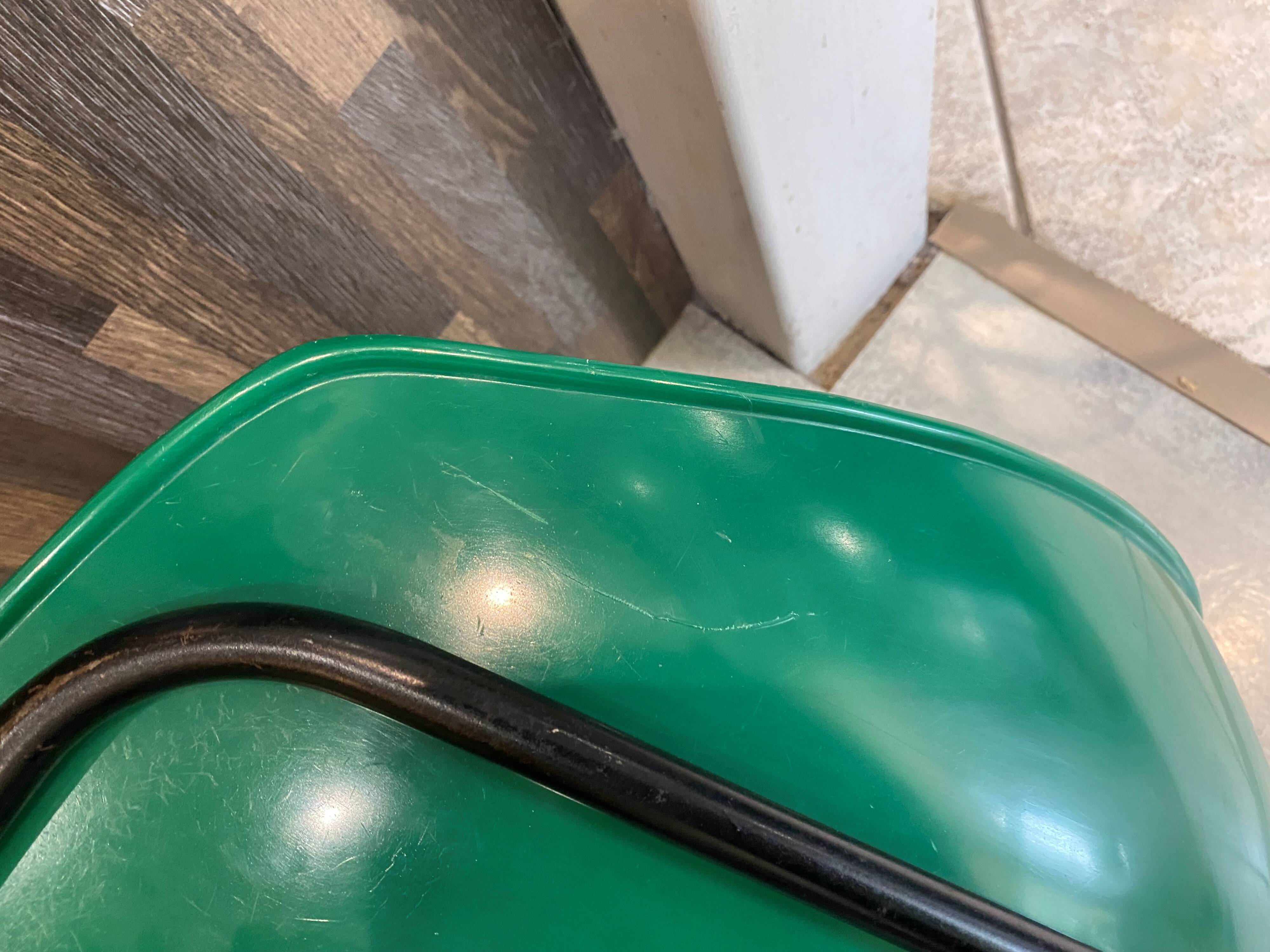 A shell chair by Pierre Guariche for Meurop in vintage green from the 1960s.