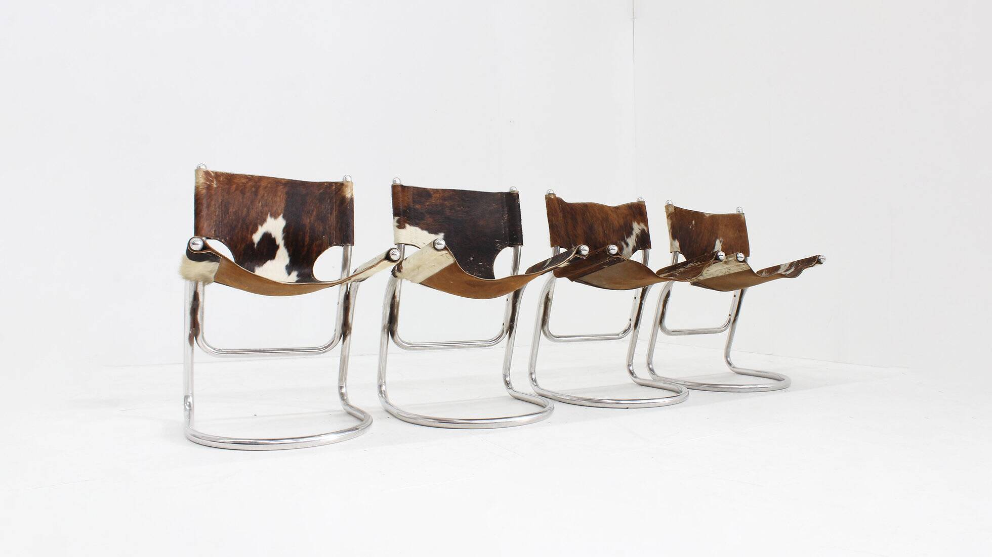 Vintage dining room chairs chrome and cowhide by Parravicini Fratelli