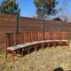 Set of 8 teak lounge chairs with high backs and zebra-striped seats