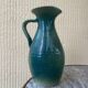 Vintage blue-green enamelled earthenware carafe