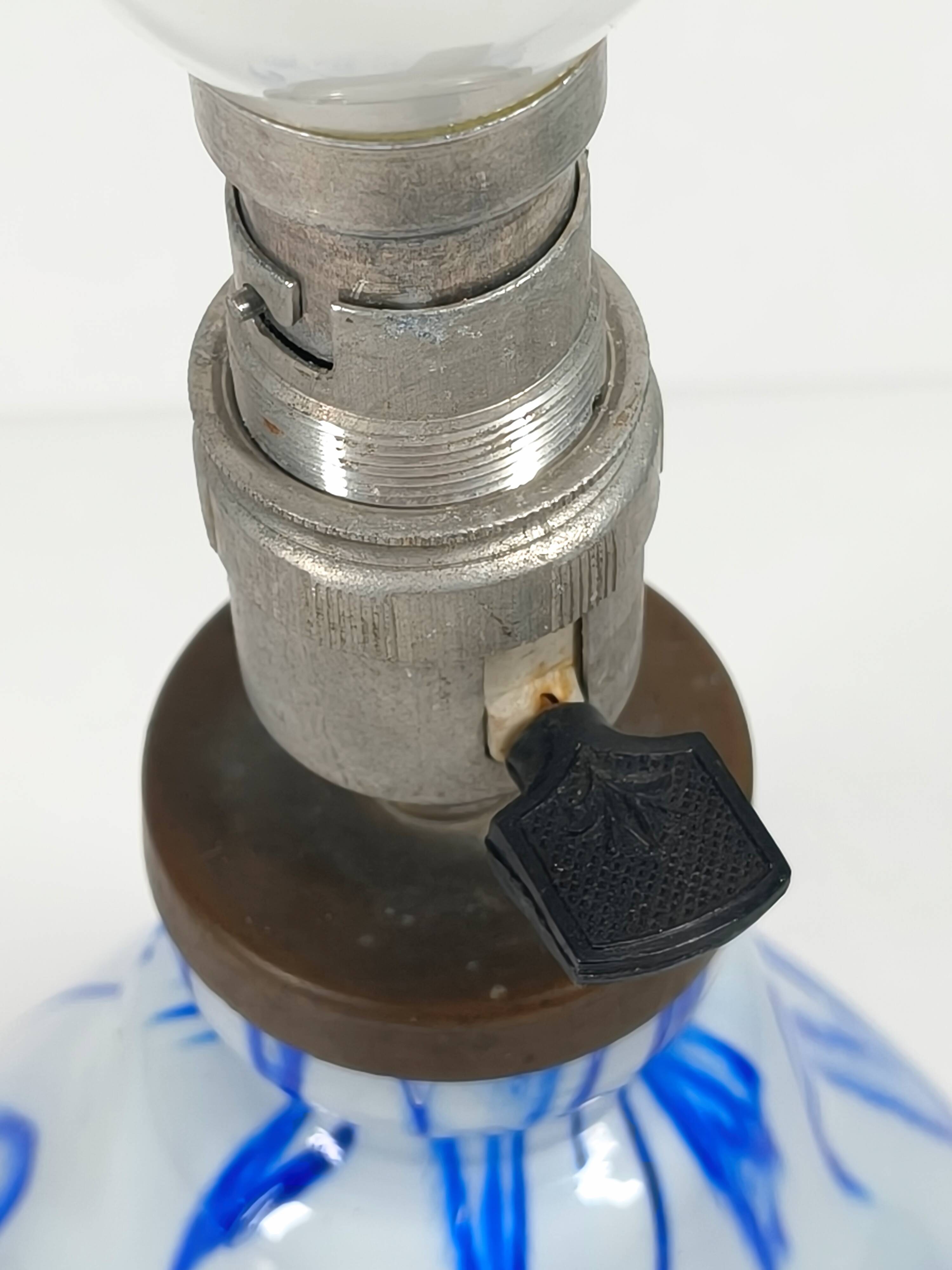 Antique table lamp in opaline glass with blue floral decoration.