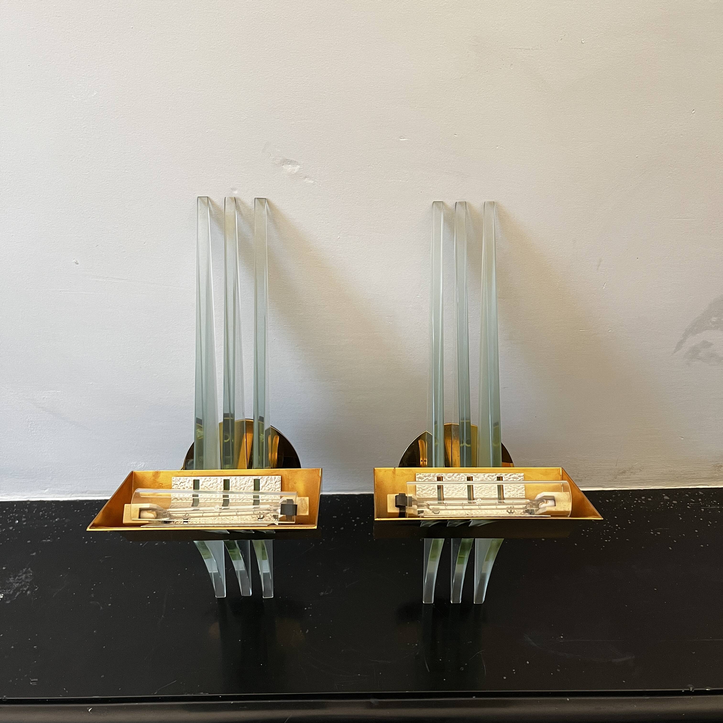 Pair of Hollywood Regency wall lights, bases & reflectors in gilded brass