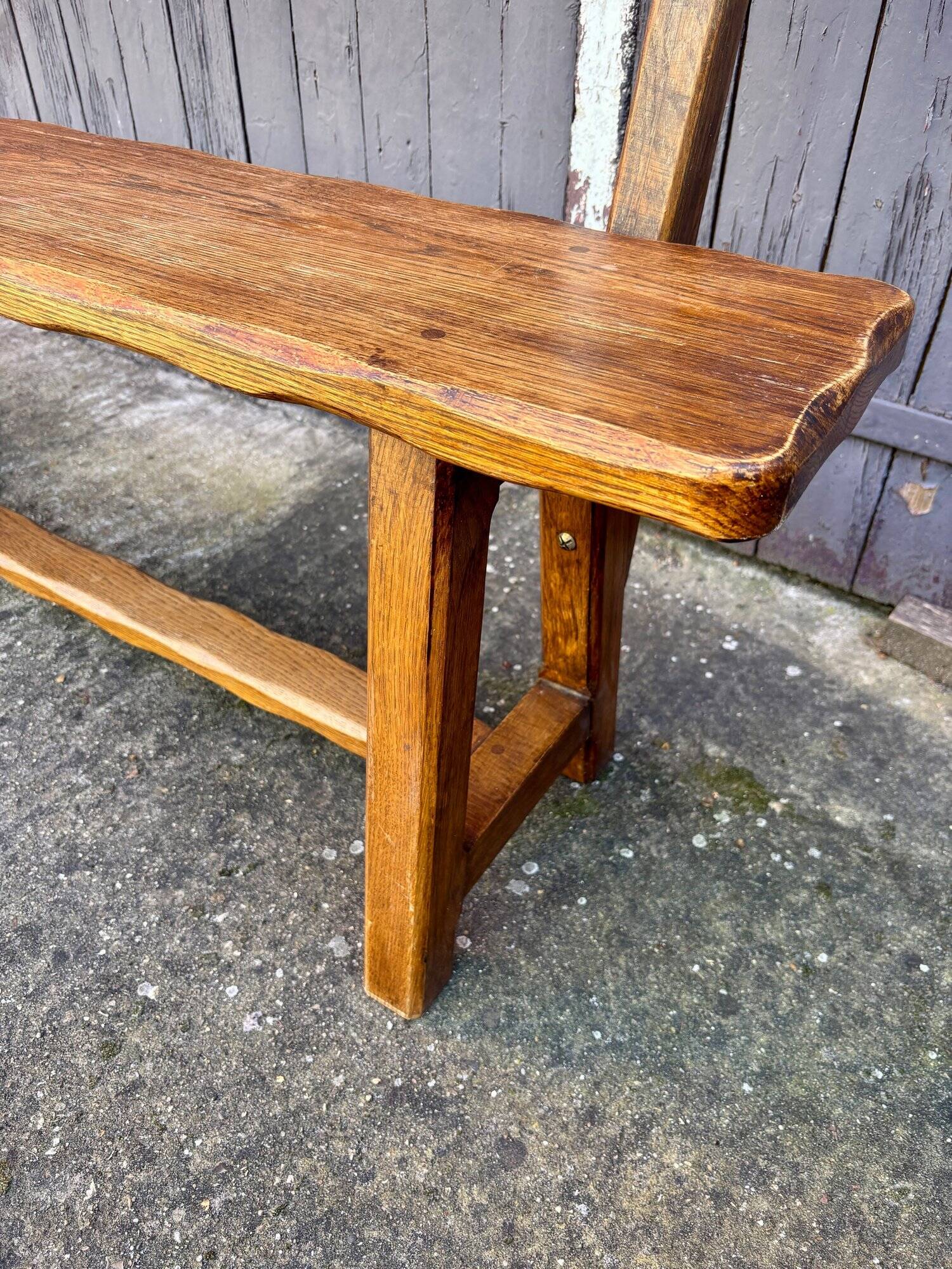 Brutalist bench with dark wood back