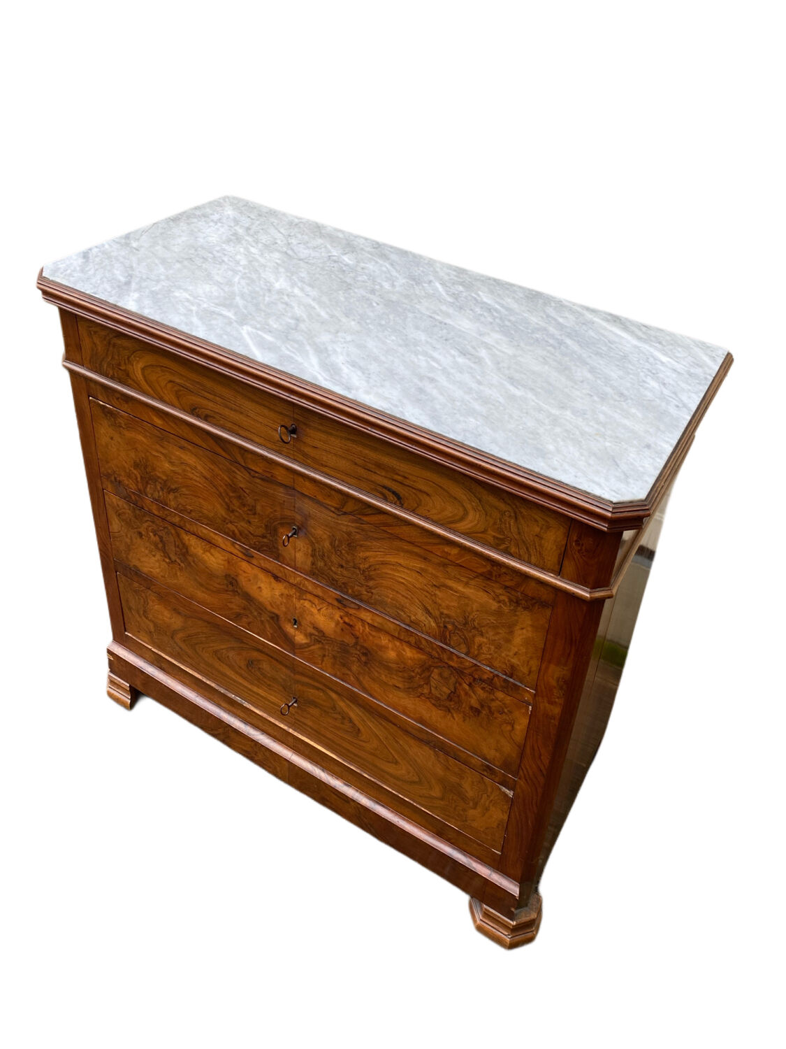 Antique Louis Philippe style chest of drawers with a white marble top.