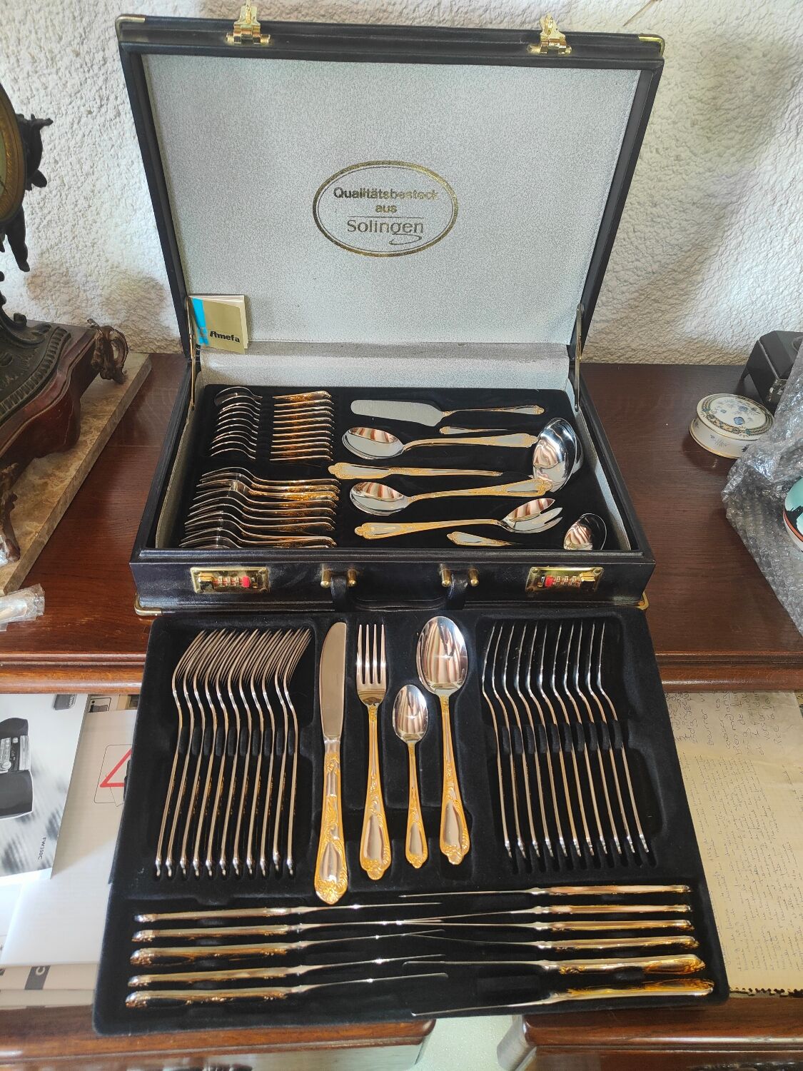 Housewife 70 covers Qualitats besteck Solingen in her suitcaseRostfrei