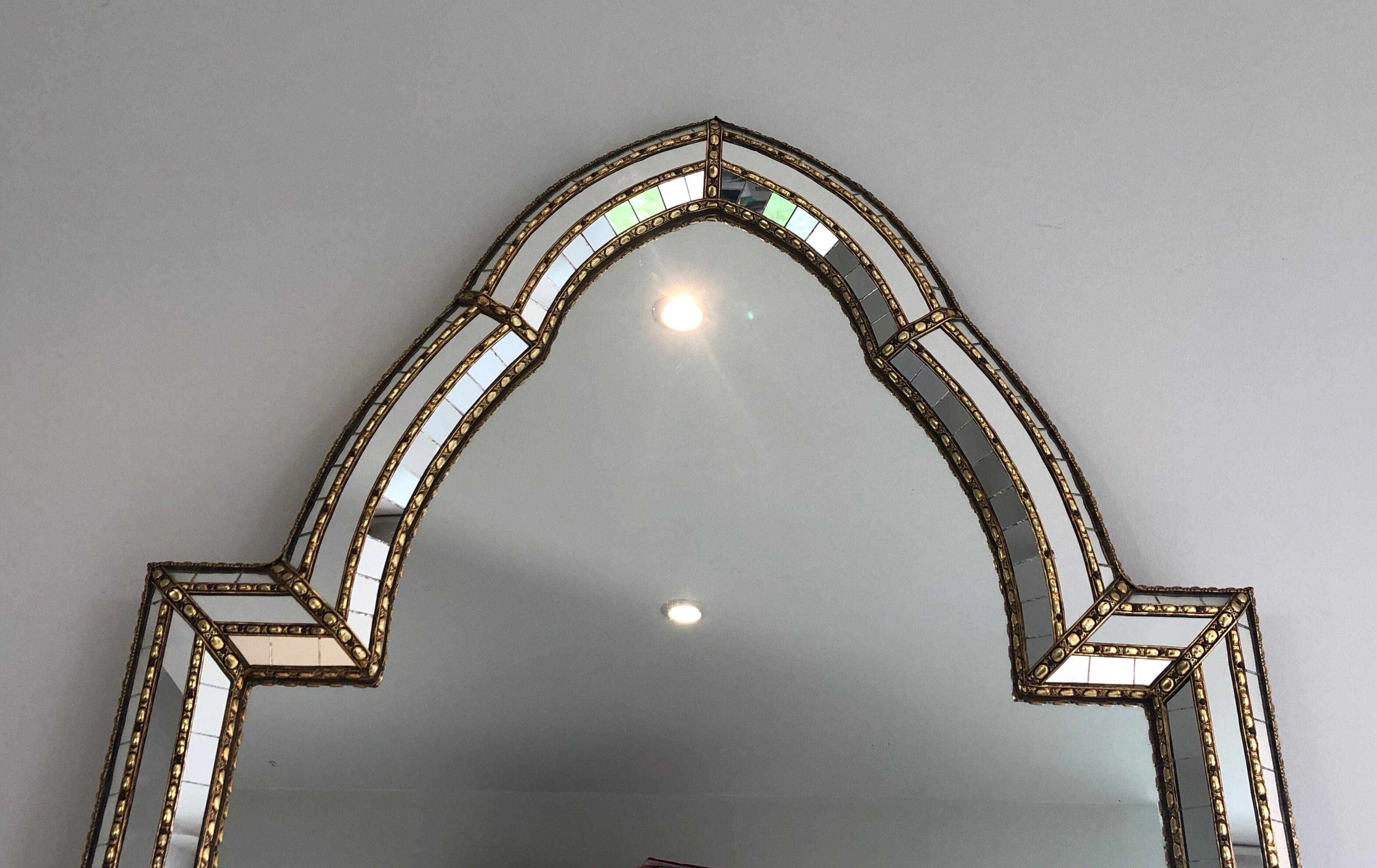 Multi-faceted mirror and brass garlands