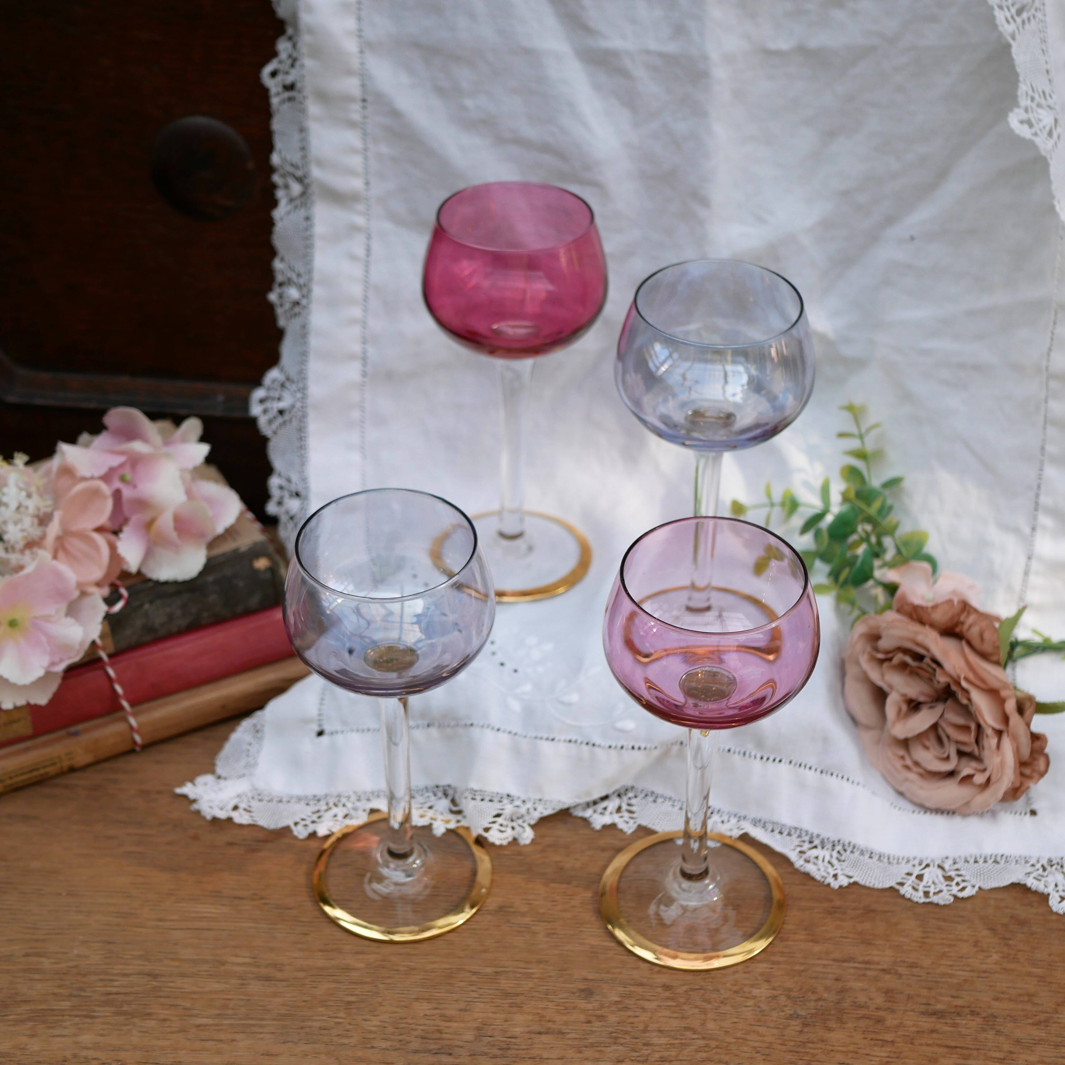 Four colorful stemmed wine glasses
